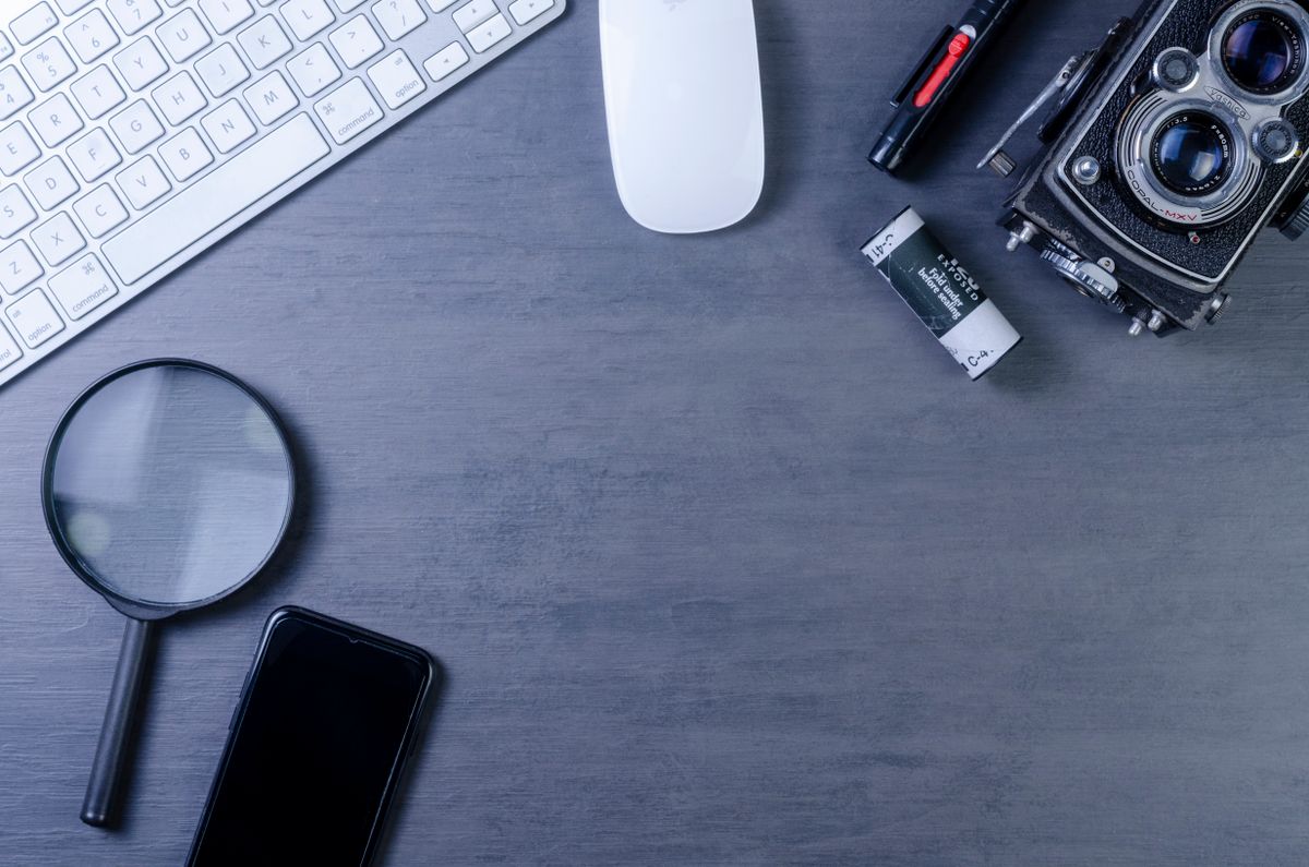 A magnifying glass and keyboard on a desk, for our Usenet search engine sites guide